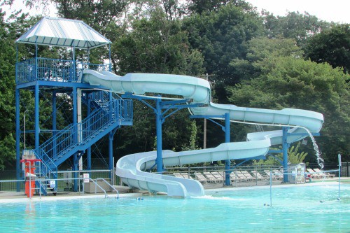 A swimming pool with a water slide.
