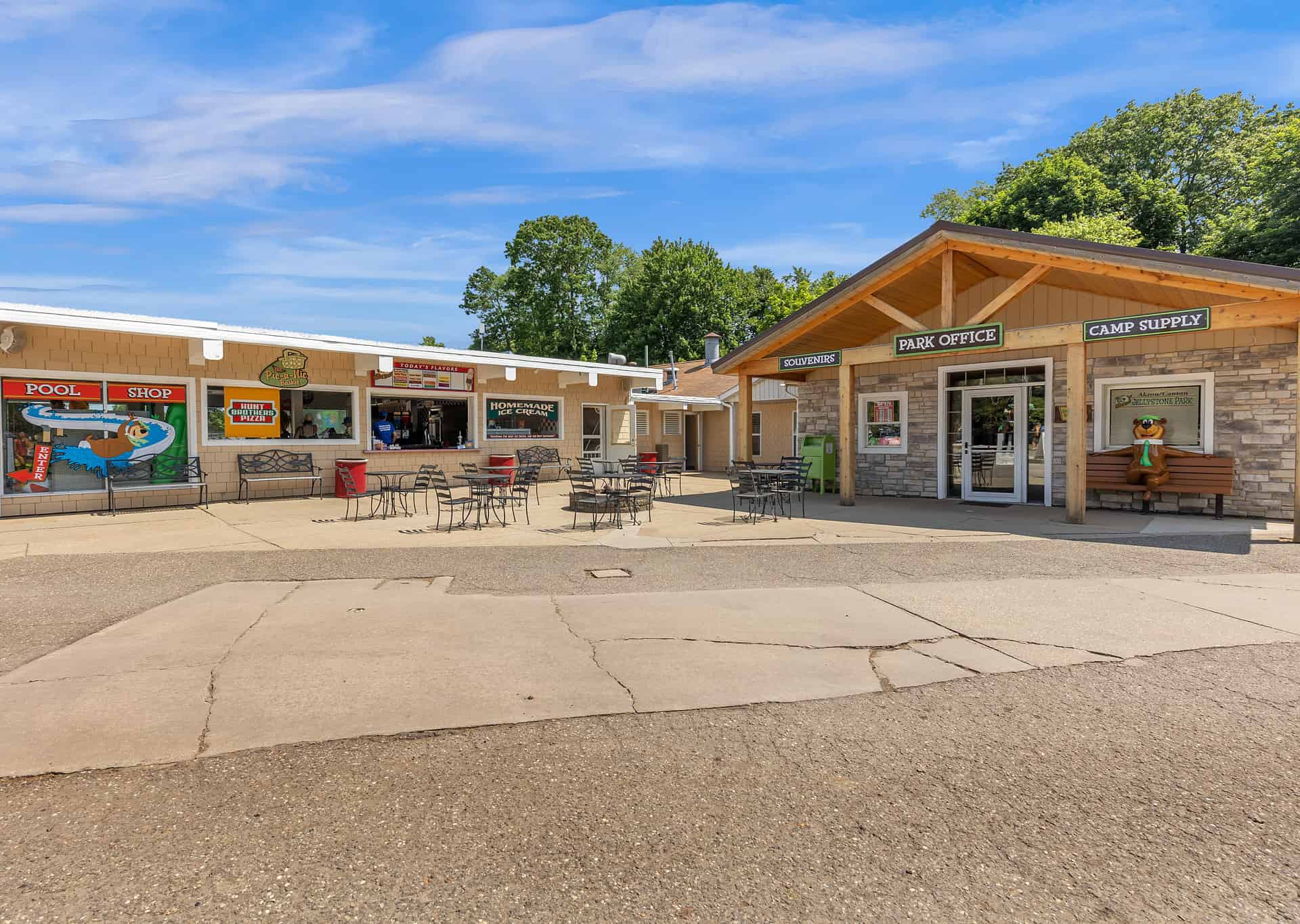 The outside of a restaurant with tables and chairs.