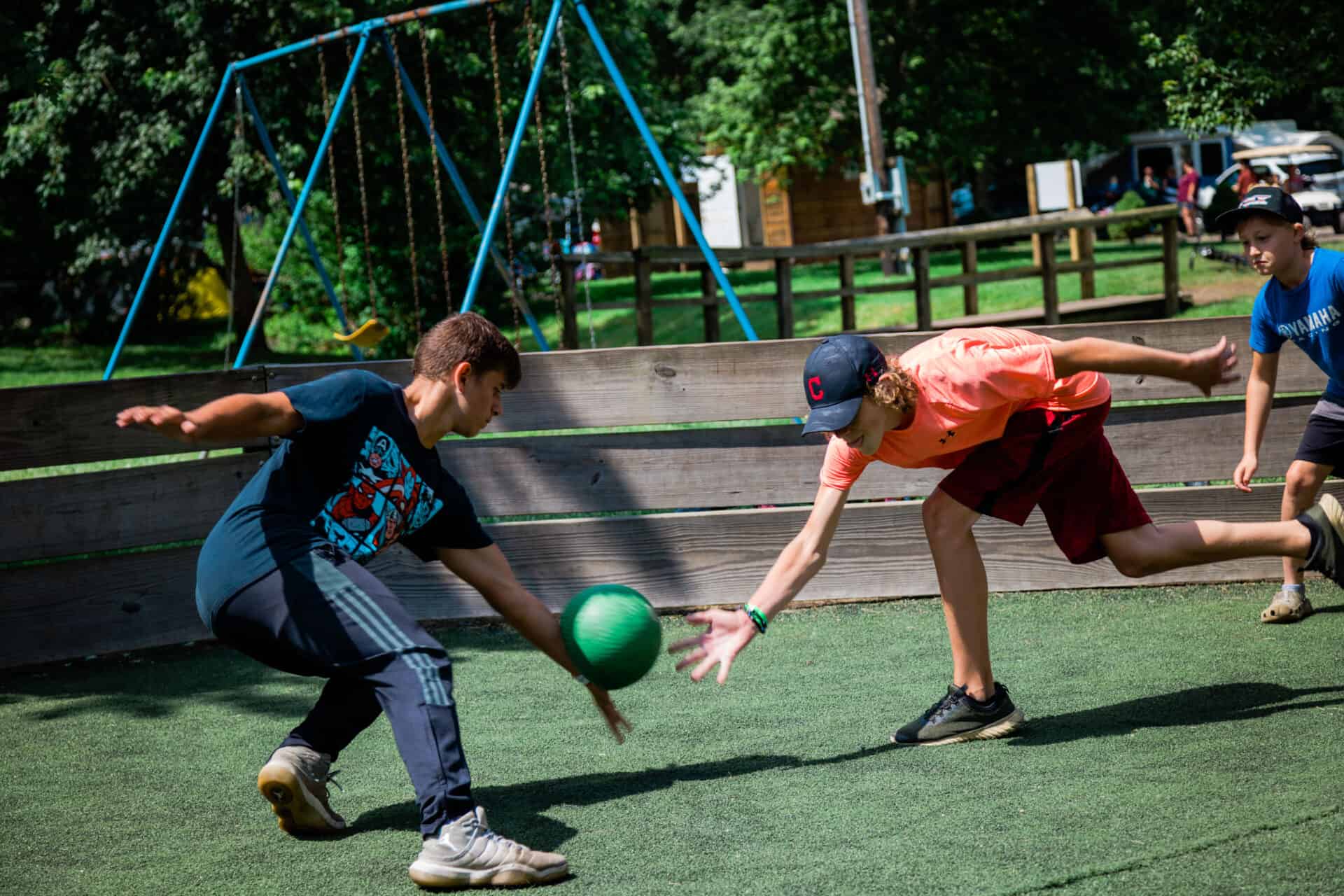 Two boys engaged in activities play a game of frisbee on a playground.