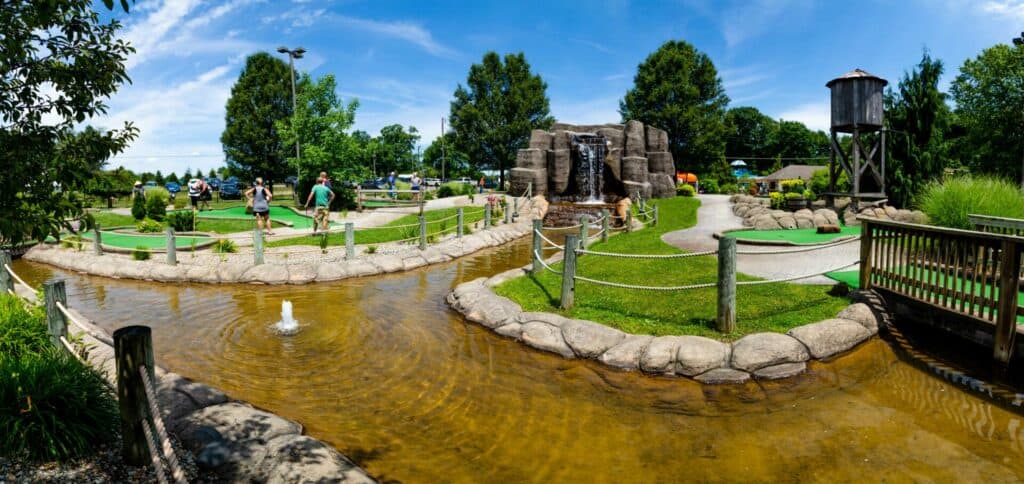 A miniature golf course with a water feature.