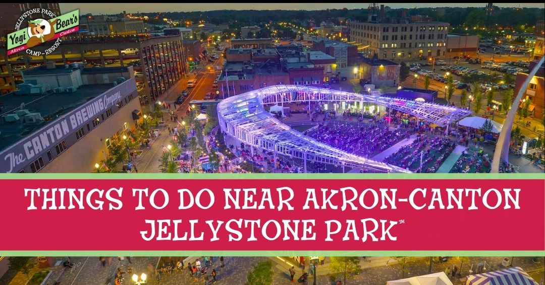 Aerial view of a lively outdoor event with colorful lights in an urban area; text reads “Things to do near Akron-Canton Jellystone Park.”.