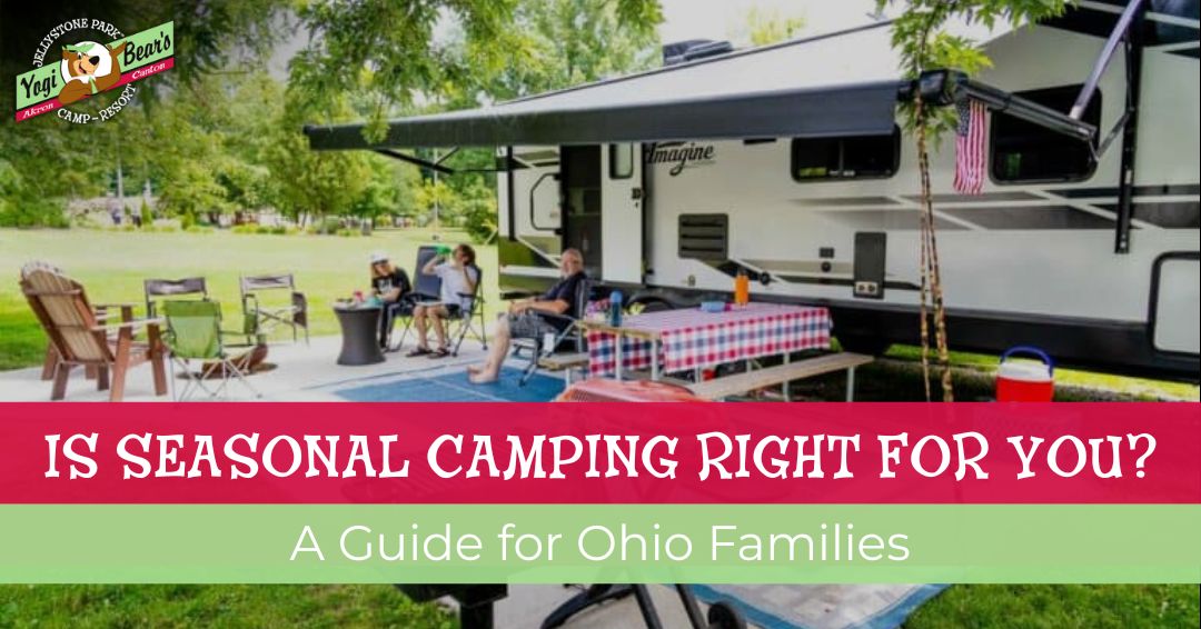 A family sits outside an RV at a campsite with lawn chairs, a picnic table, and camping gear, beneath a large awning on a grassy area.
