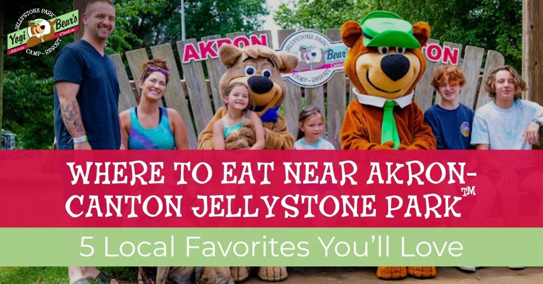 A group of people and two costumed characters pose for a photo in front of a Jellystone Park sign; text promotes local dining near Akron-Canton Jellystone Park.