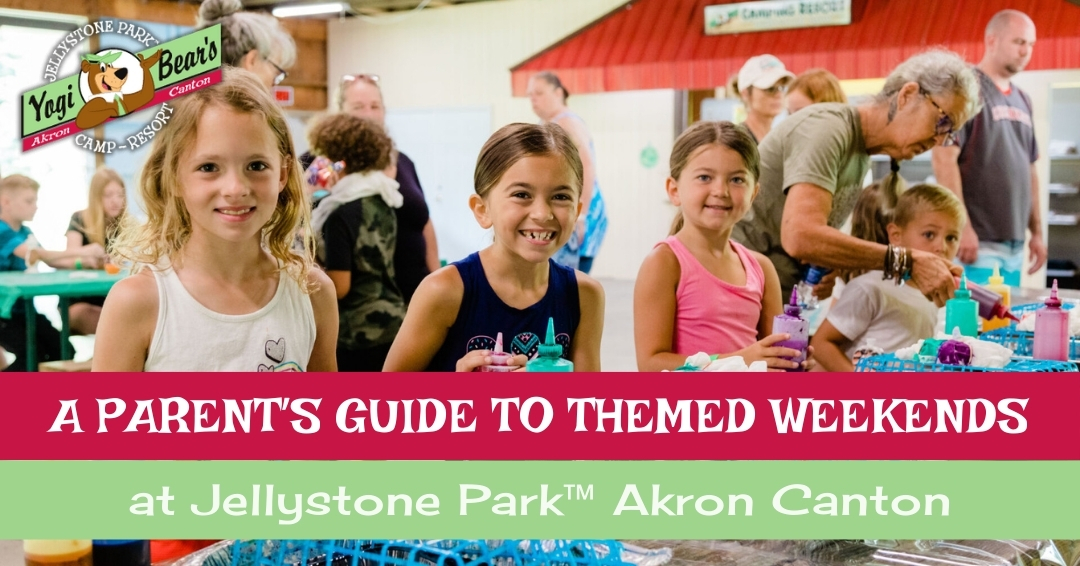 Children and adults participate in a crafts activity at a Jellystone Park indoor event, with the text promoting themed weekends at the Akron Canton location.